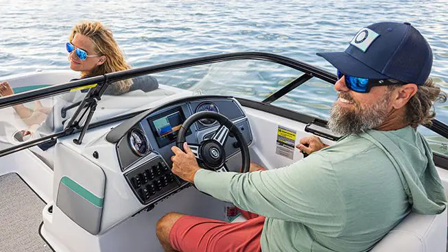 steering wheel and gauges on the helm of a hurricane sundeck ob boat