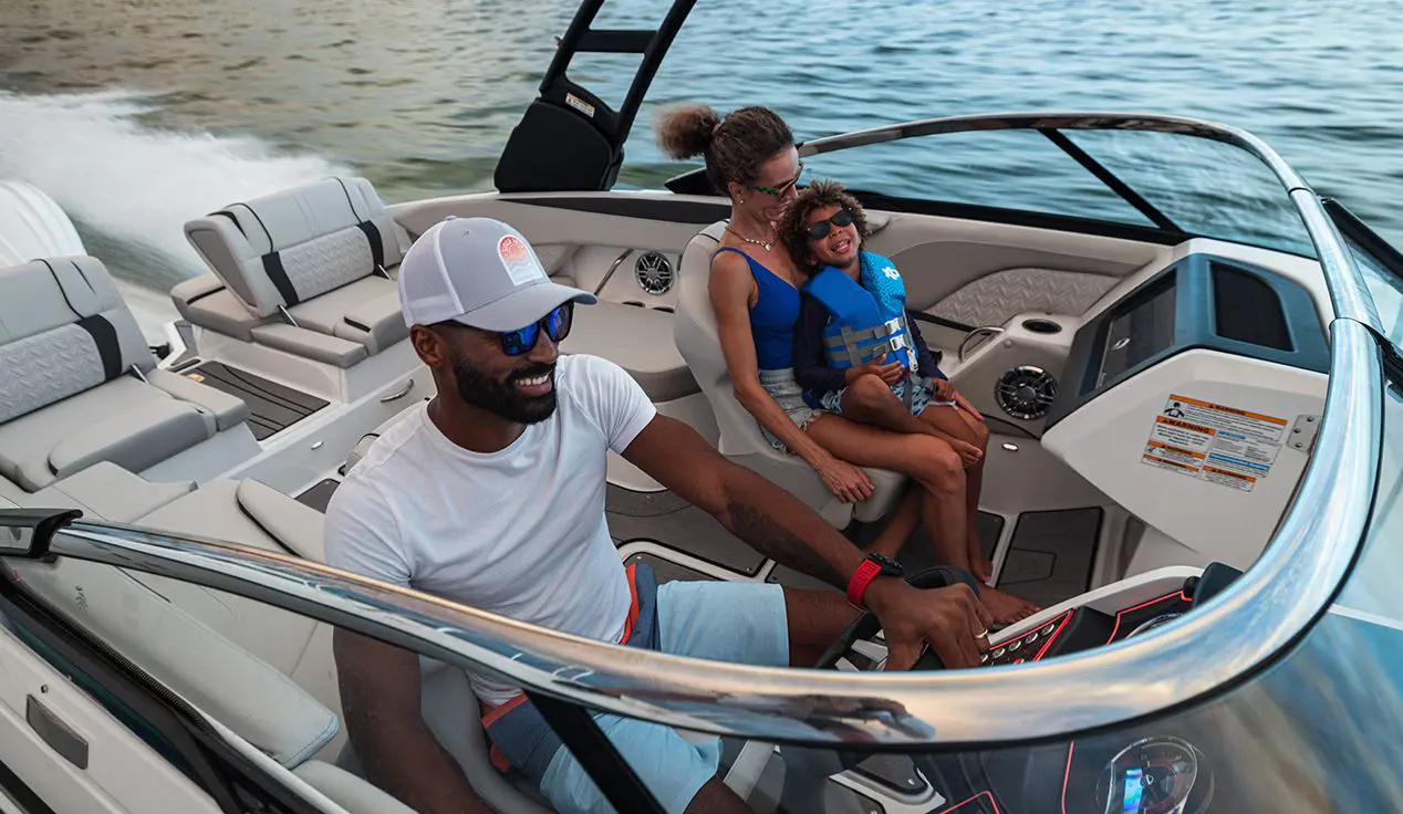 family enjoying the water on a hurricane sundeck ob boat