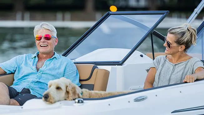 a couple smiling on a hurricane sundeck ob boat