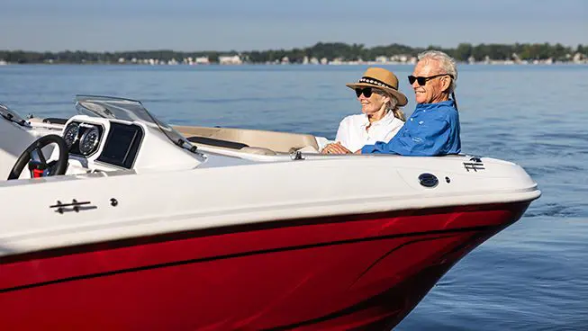 A couple relaxing on a Hurricane SunDeck OB deck boat.