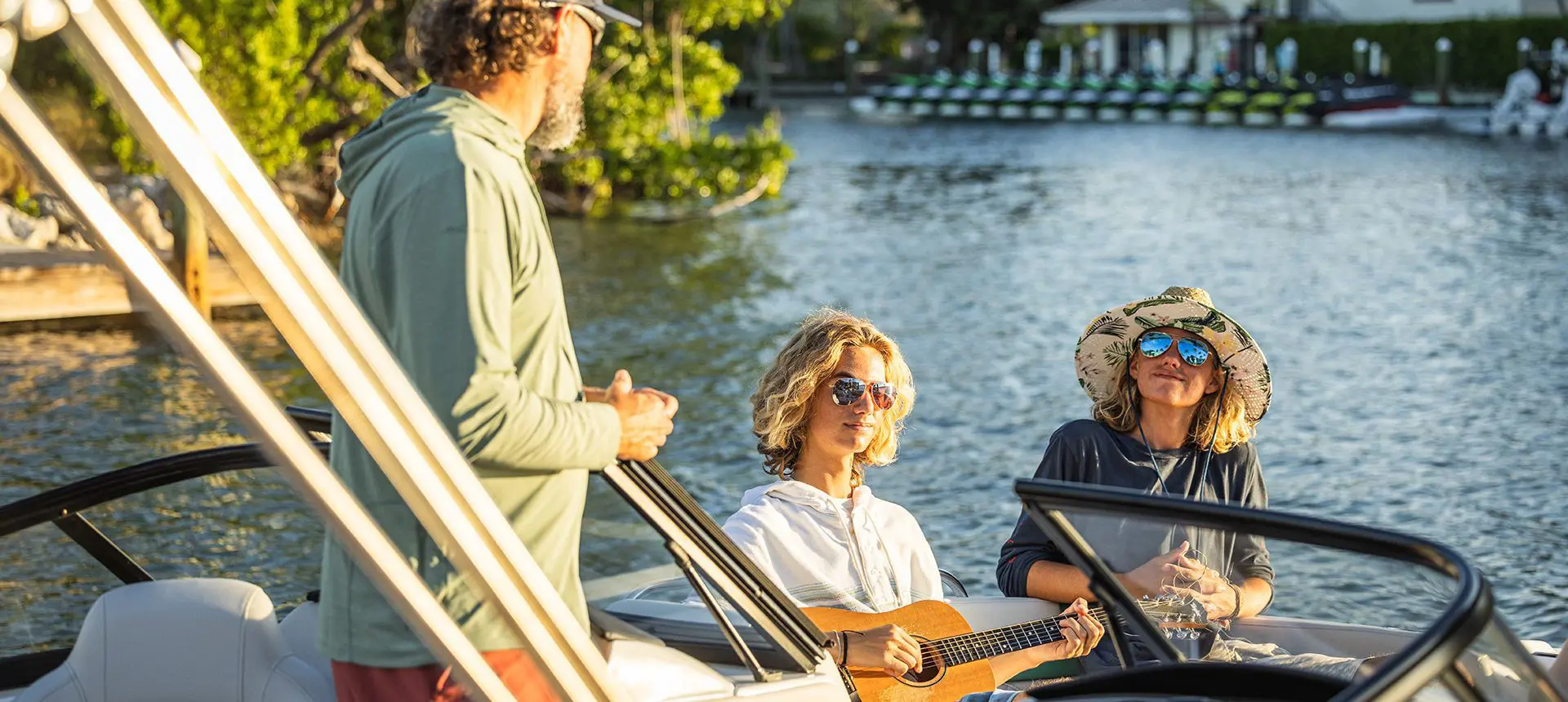 person playing guitar on a hurricane entertainment boat