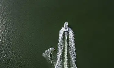 aerial view of a hurricane entertainment boat pulling a wakeboarder