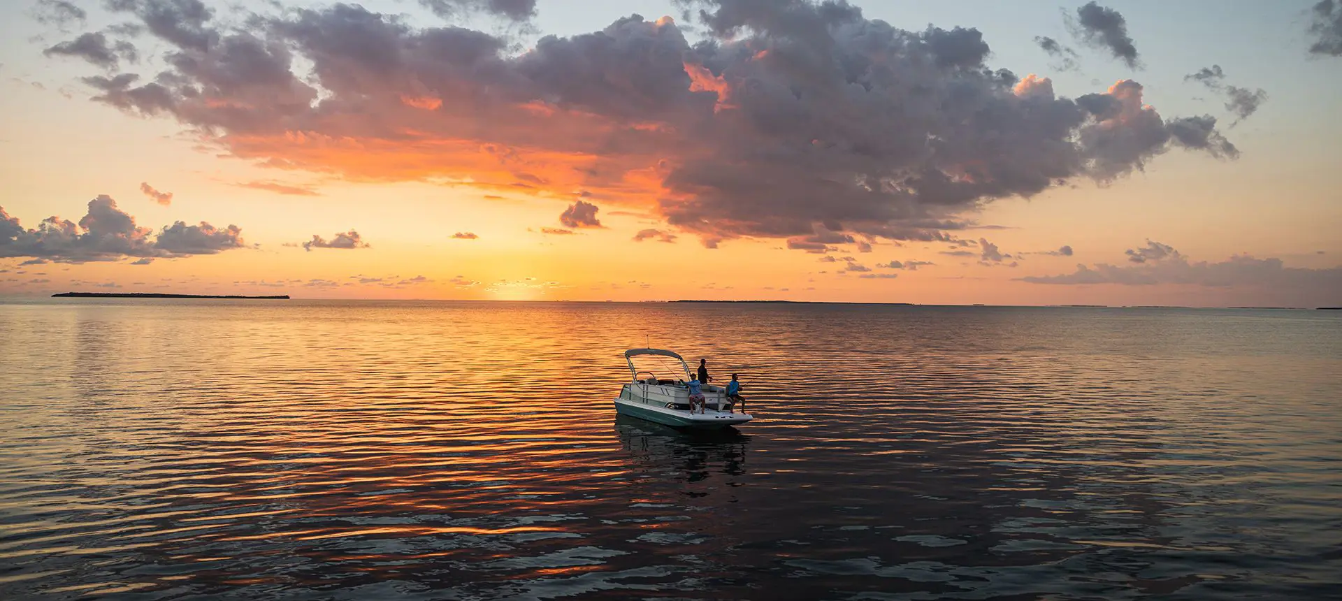 People fishing off a Hurricane deck boat on the ocean.