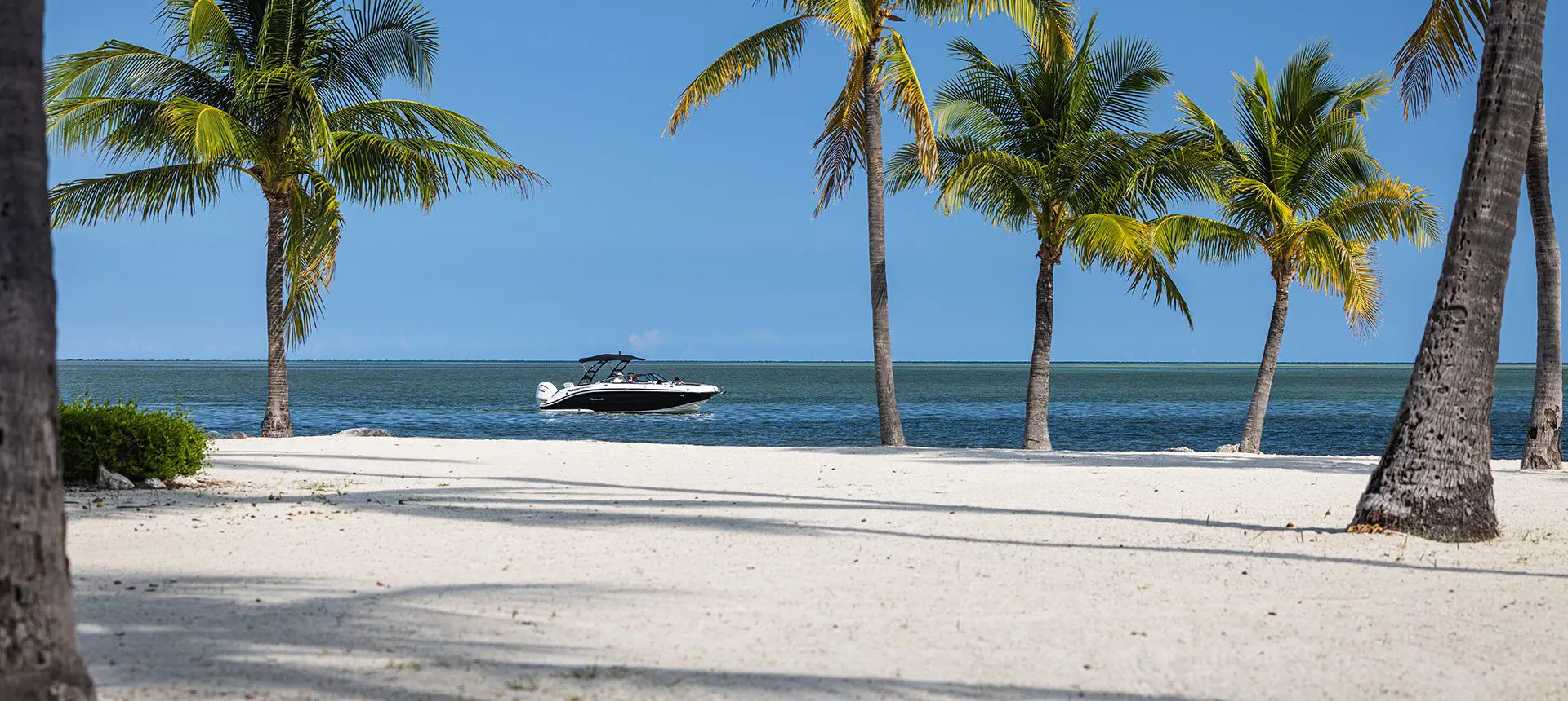 Hurricane deck boat on the ocean near the beach.