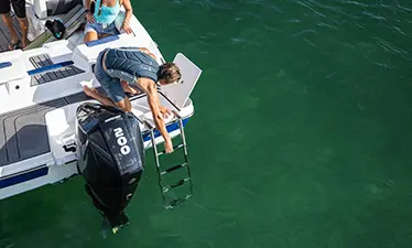 Person putting down the stern ladder on a Hurricane sport boat.