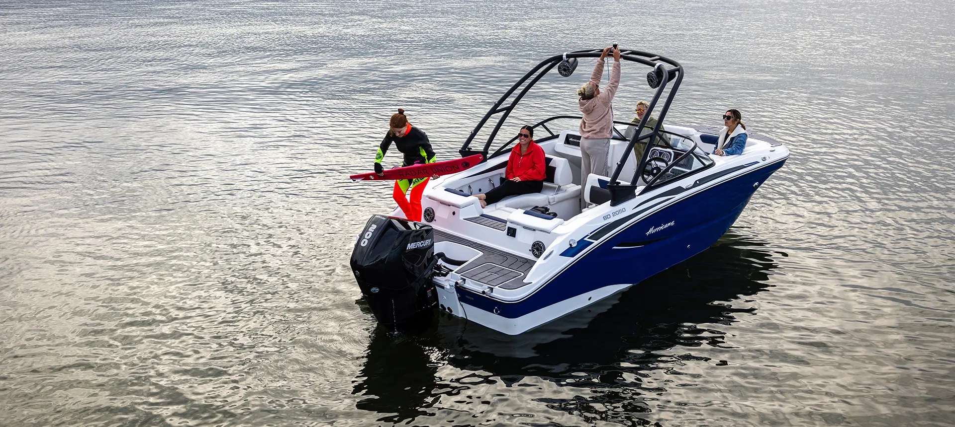 person getting ready to water ski behind a hurriance sport boat
