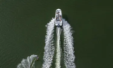 Wakeboarder towed behind a Hurricane sport boat.