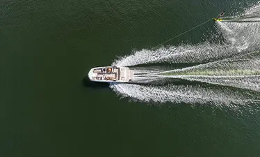 Overhead view of Hurricane watersports boat pulling a skier.