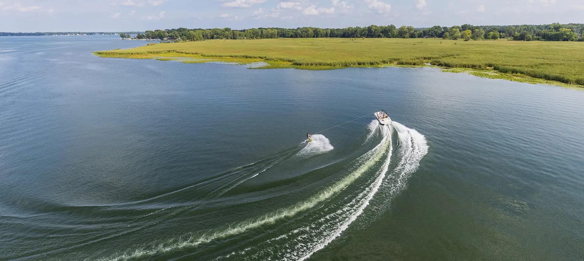 Wake boarder being pulled by a Hurricane sport boat.