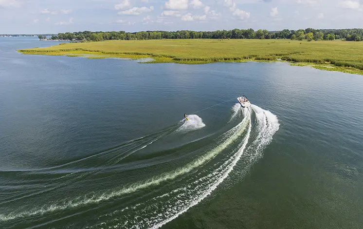 Hurricane watersports boat pulling a wakeboarder.