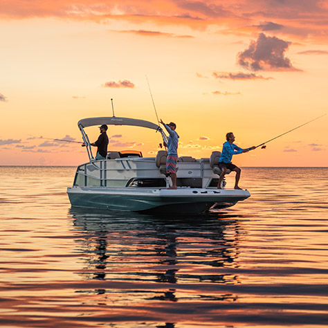 3 people fishing off the bow of a Hurricane deck boat.