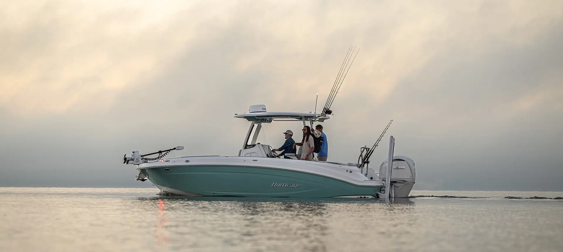 Side profile of 2 men preparing to fish on a Hurricane Center Console fishing deck boat.