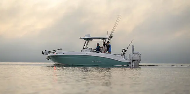 Side profile of 2 men preparing to fish on a Hurricane Center Console fishing deck boat.
