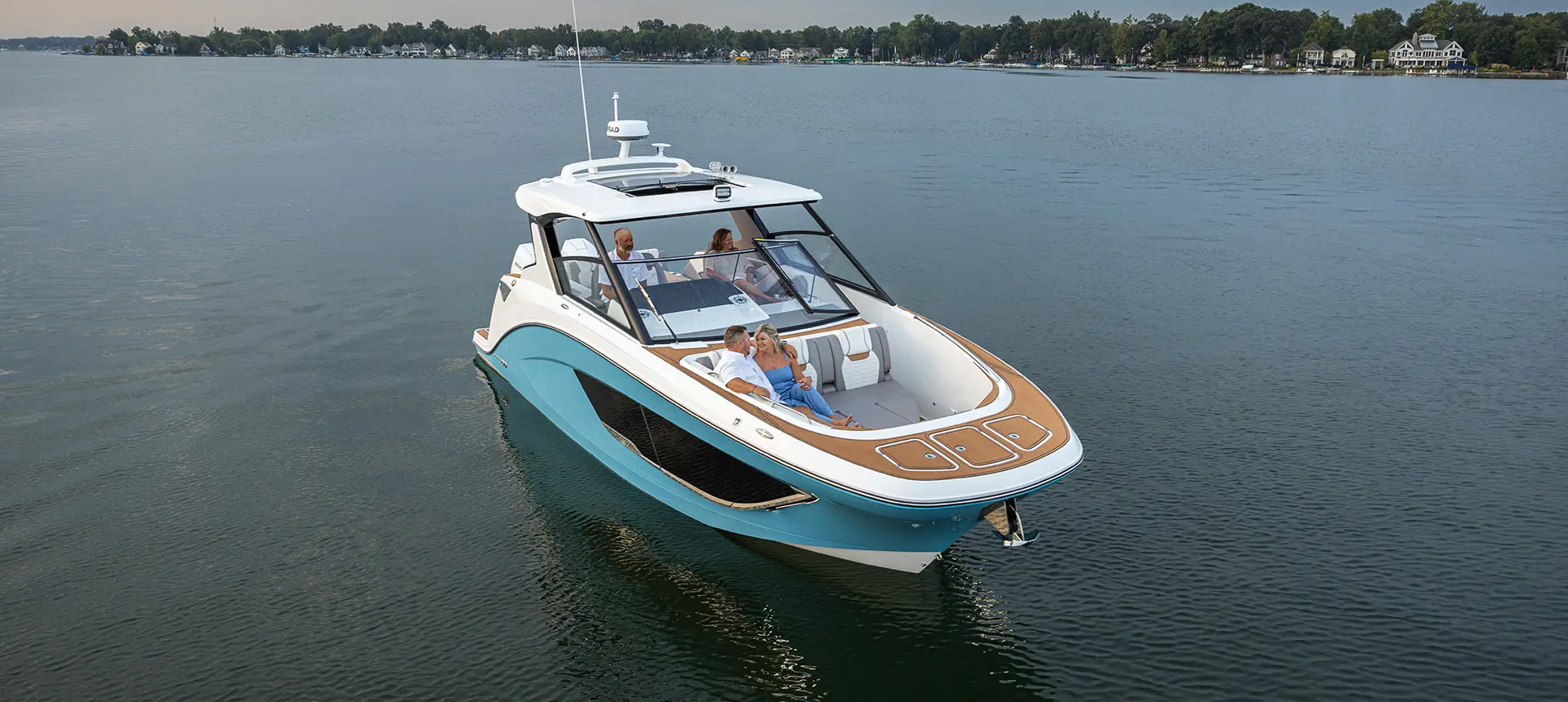 Aerial view of 4 people enjoying the lake while on a Hurricane SunDeck 3200 OB Yacht Series deck boat.