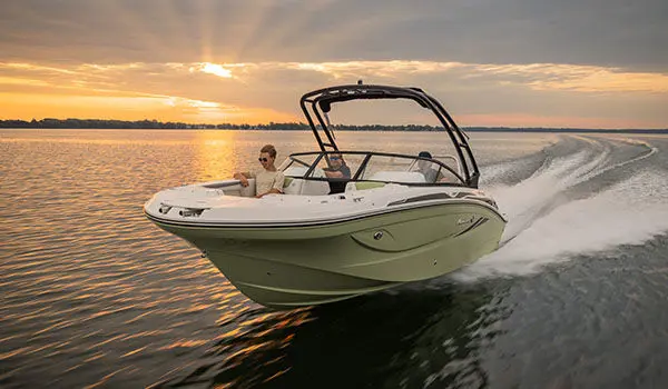 Side-view of Hurricane Sundeck 2050 OB on the water.