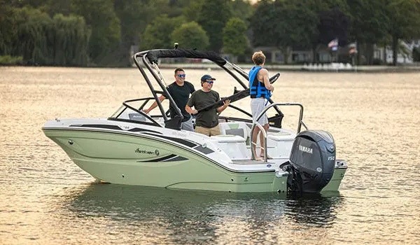 Rear-view of a parked Hurricane Sundeck 2050 OB on the water.