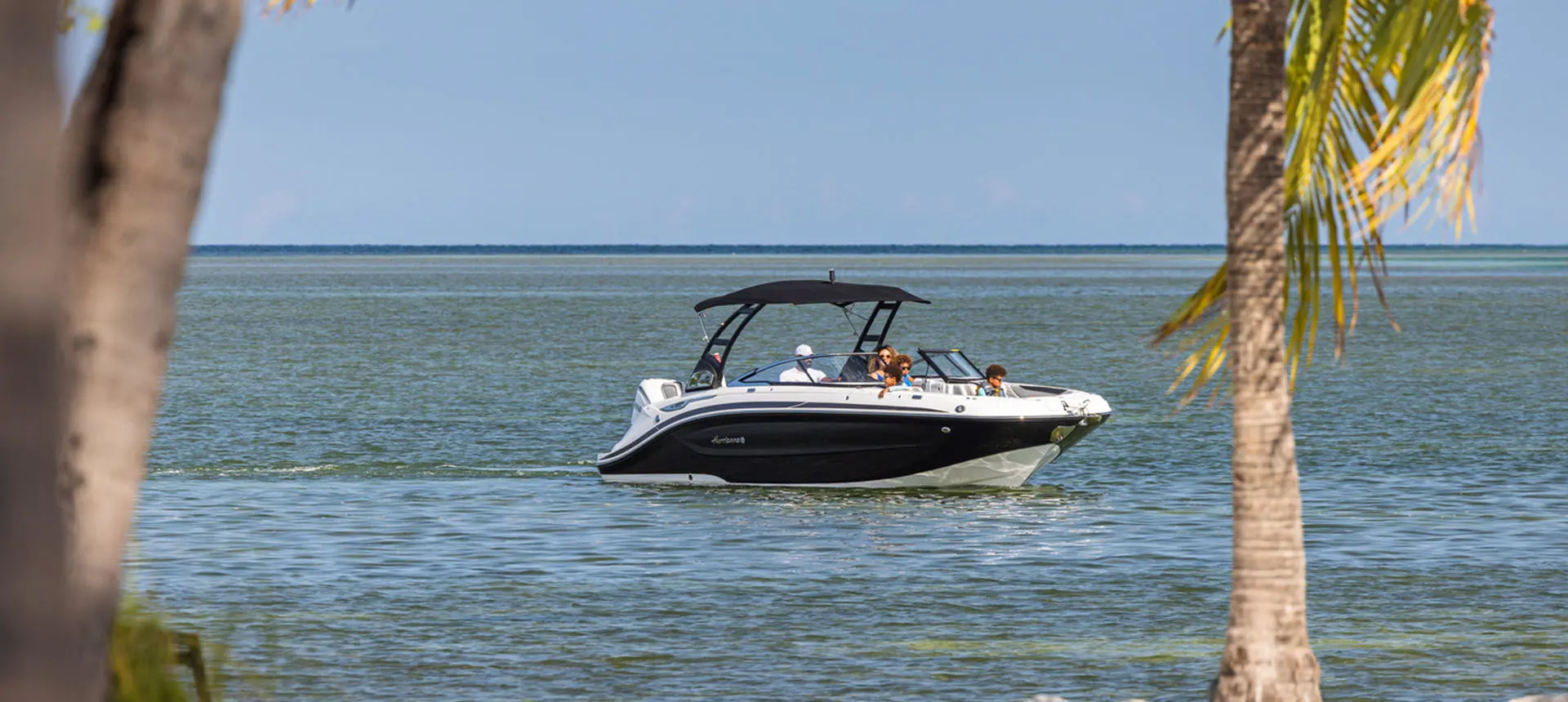 Hurricane Sundeck 2600 OB deck boat approaching land.