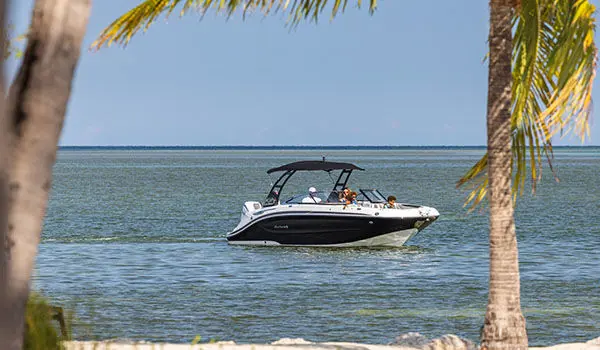 Hurricane Sundeck 2600 OB deck boat approaching land.