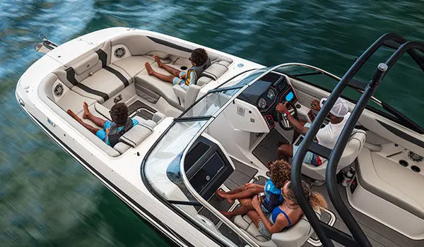 Overhead view of family cruising ocean on a Hurricane Sundeck 2600 OB deck boat.
