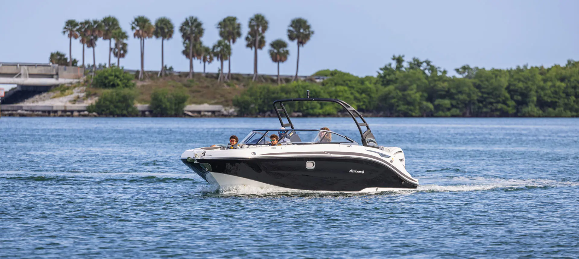 Hurricane Sundeck 2600 OB deck boat cruising on the ocean.