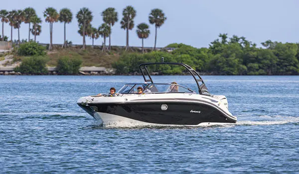 Hurricane Sundeck 2600 OB deck boat cruising on the ocean.