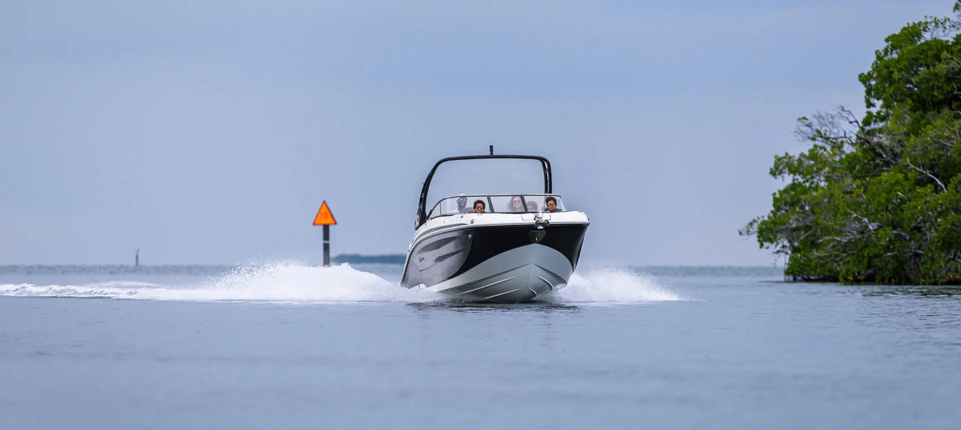 Hurricane Sundeck 2600 OB deck boat cruising on the ocean.