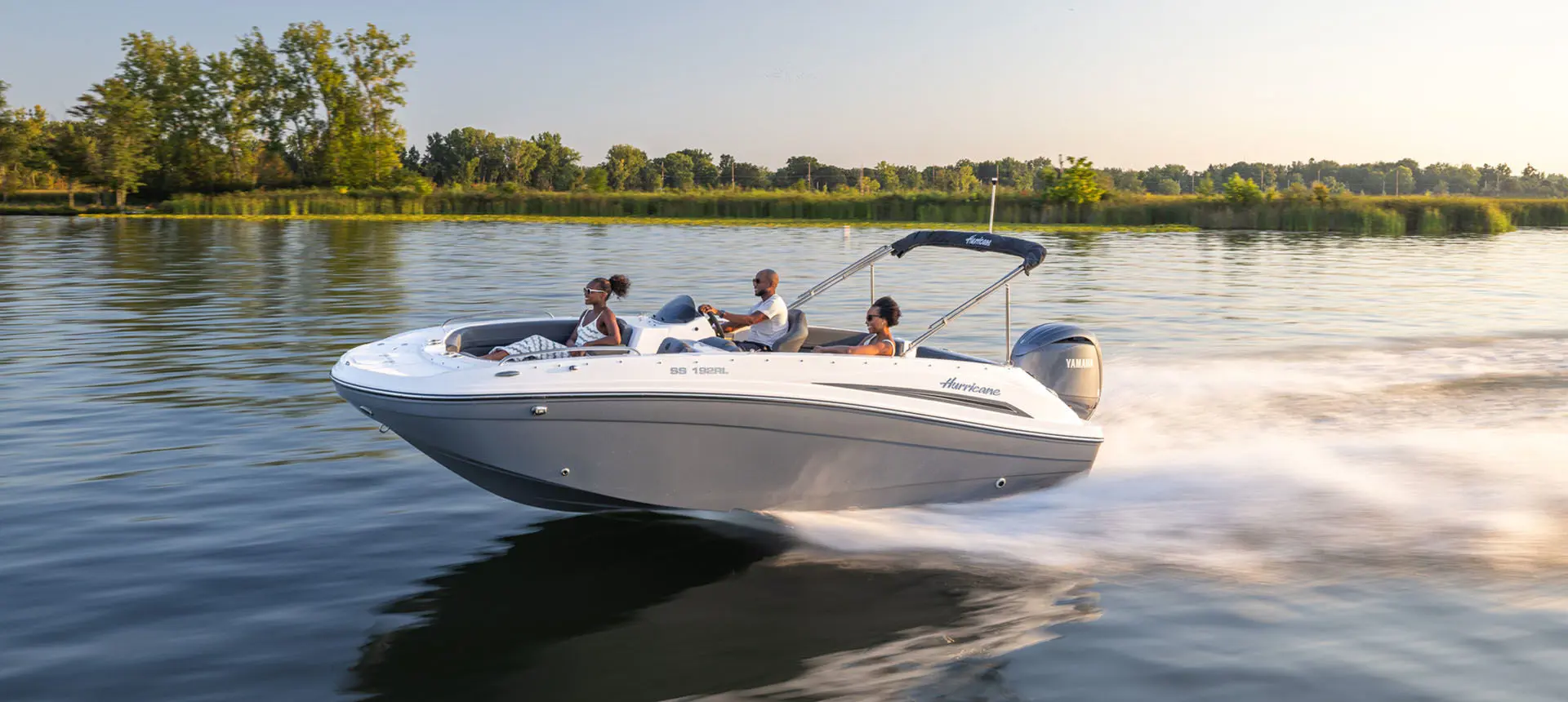 Front view of family cruising in a Hurricane Sundeck Sport 192 RL OB on lake.
