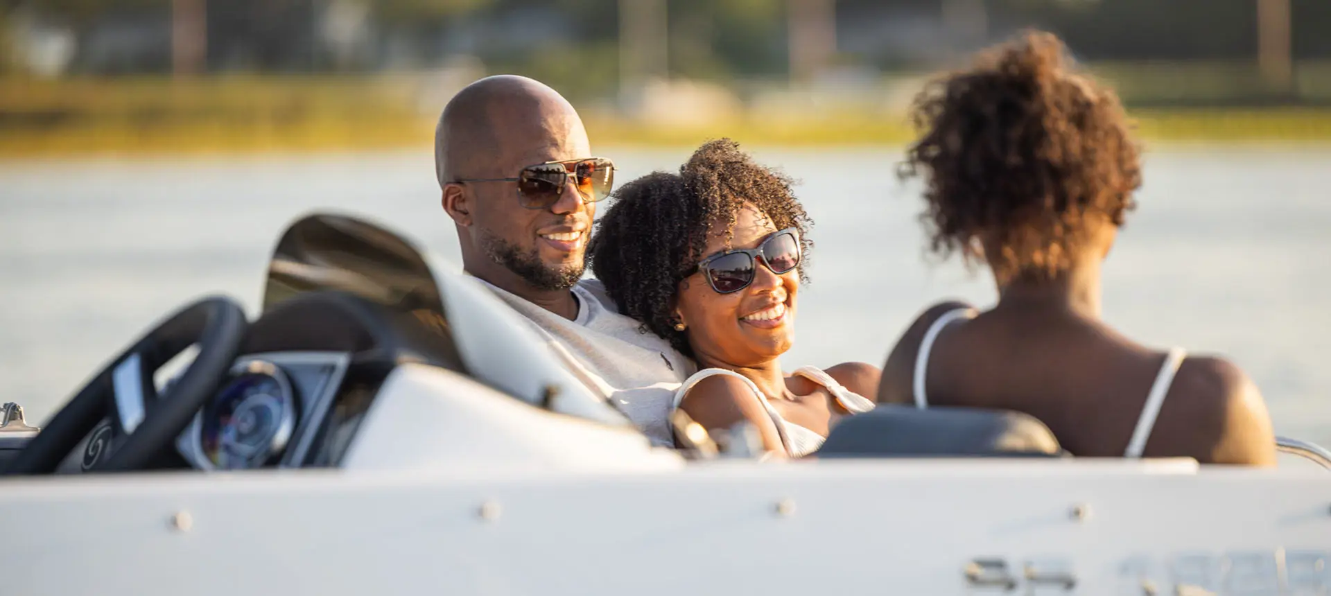 Family smiles while lounging on front seating on Hurricane Sundeck Sport 192 RL OB.