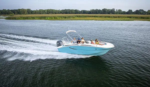 Family speeds across lake on a Hurricane Sundeck Sport 2050 OB.