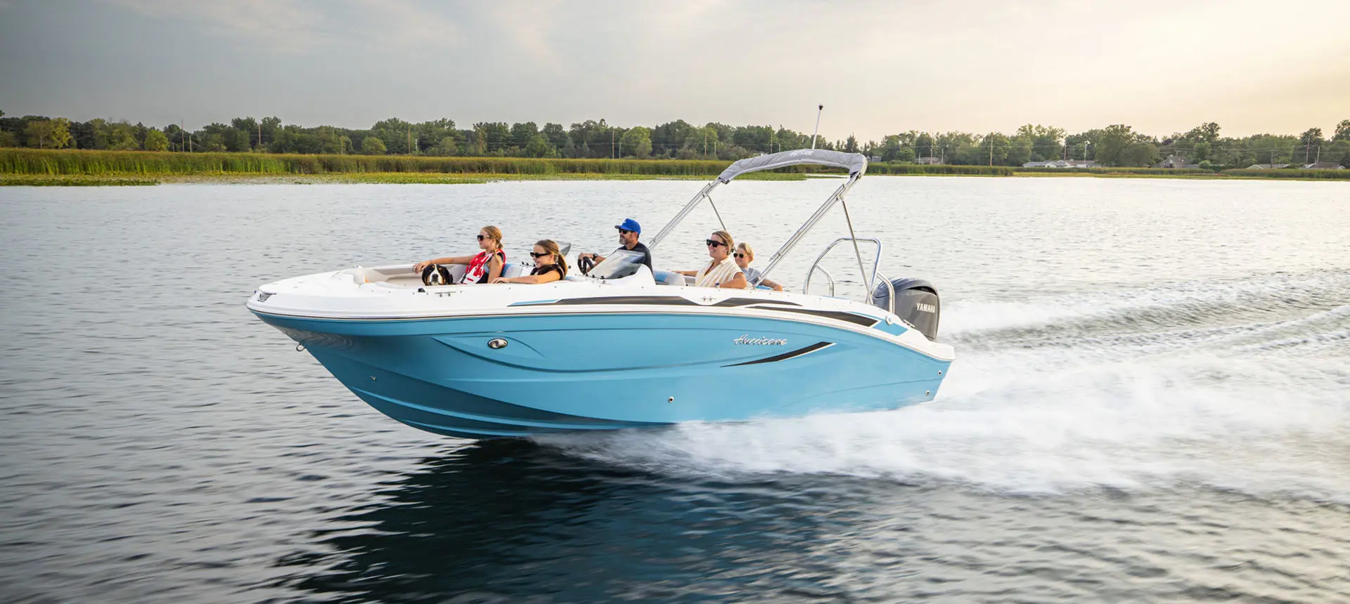 Family speeds across lake on a Hurricane Sundeck Sport 2050 OB.