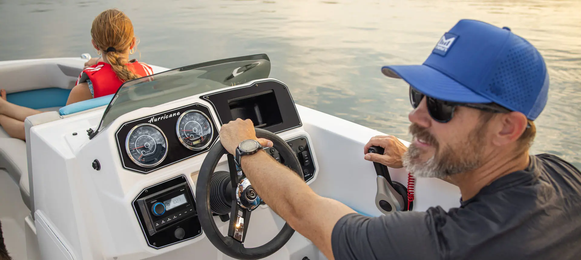 Captain steers Hurricane Sundeck Sport 2050 OB.
