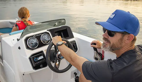 Captain steers Hurricane Sundeck Sport 2050 OB.