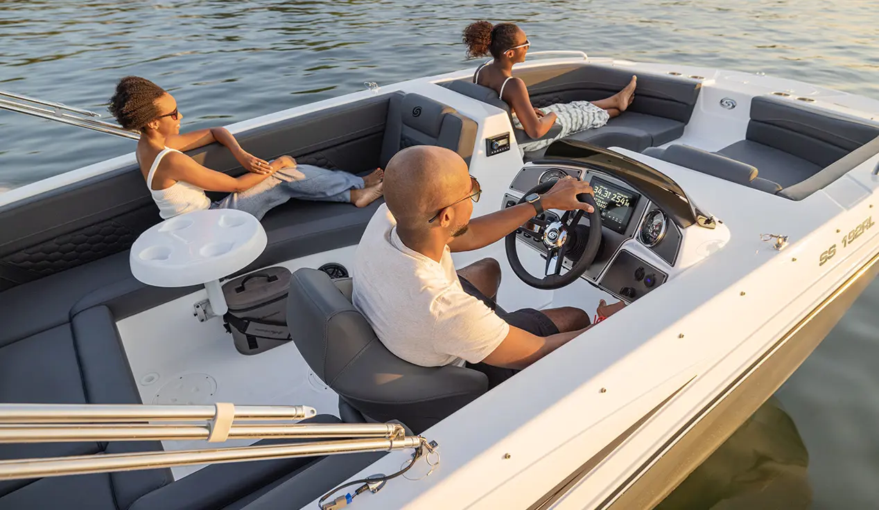 Overhead view of a family relaxing on a Hurricane SunDeck Sport OB deck boat.