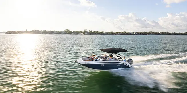 Side profile of a Hurricane yacht certified deck boat cruising on the ocean.