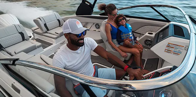 Family of 3 smiling while cruising the ocean on a Hurricane yacht certified deck boat.