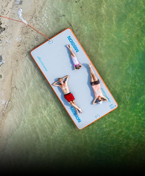Overhead view of family lounging on Hurricane Reef 85 mat. 