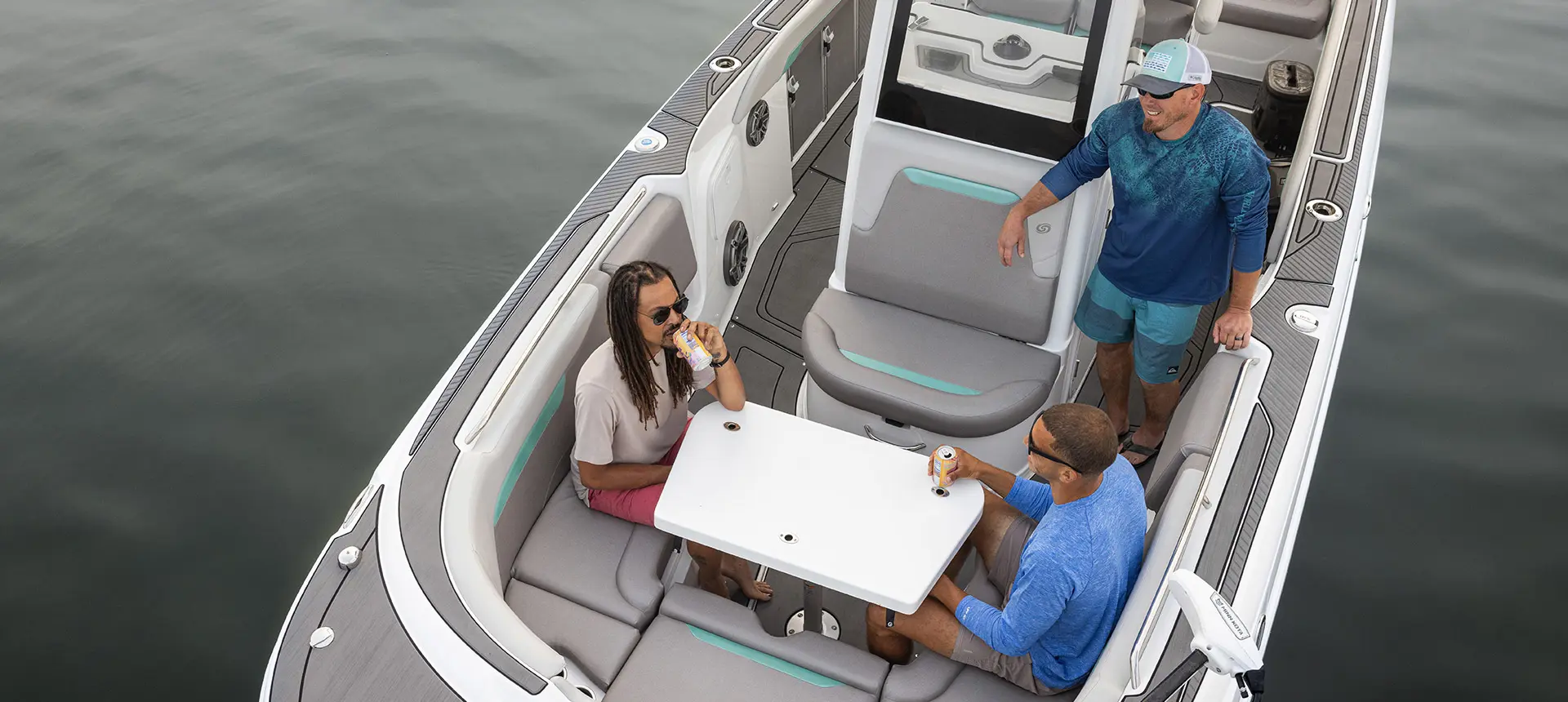 Aerial view of 3 friends at the bow table on a Hurricane Entertainment deck boat.