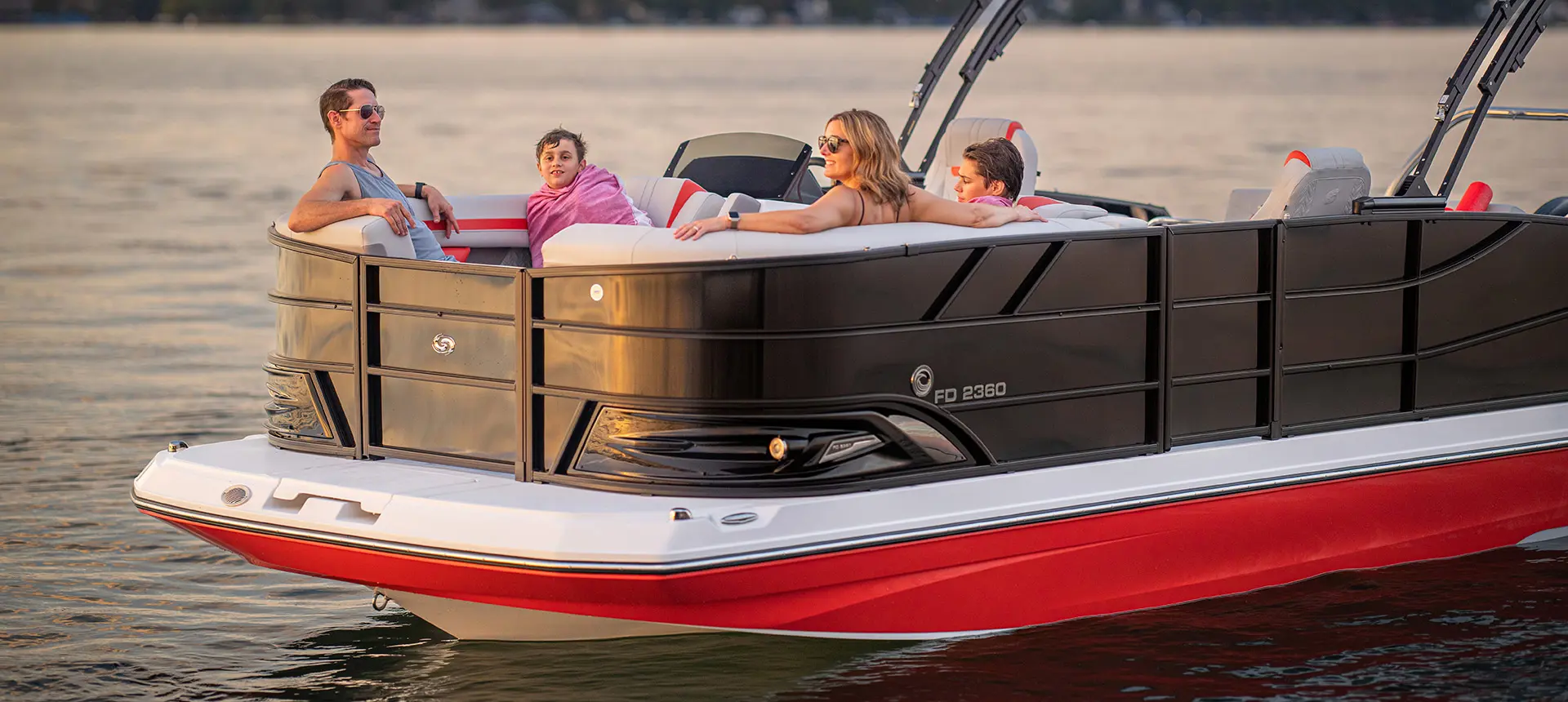 Side profile of a family relaxing on a Hurricane Entertainment deck boat.