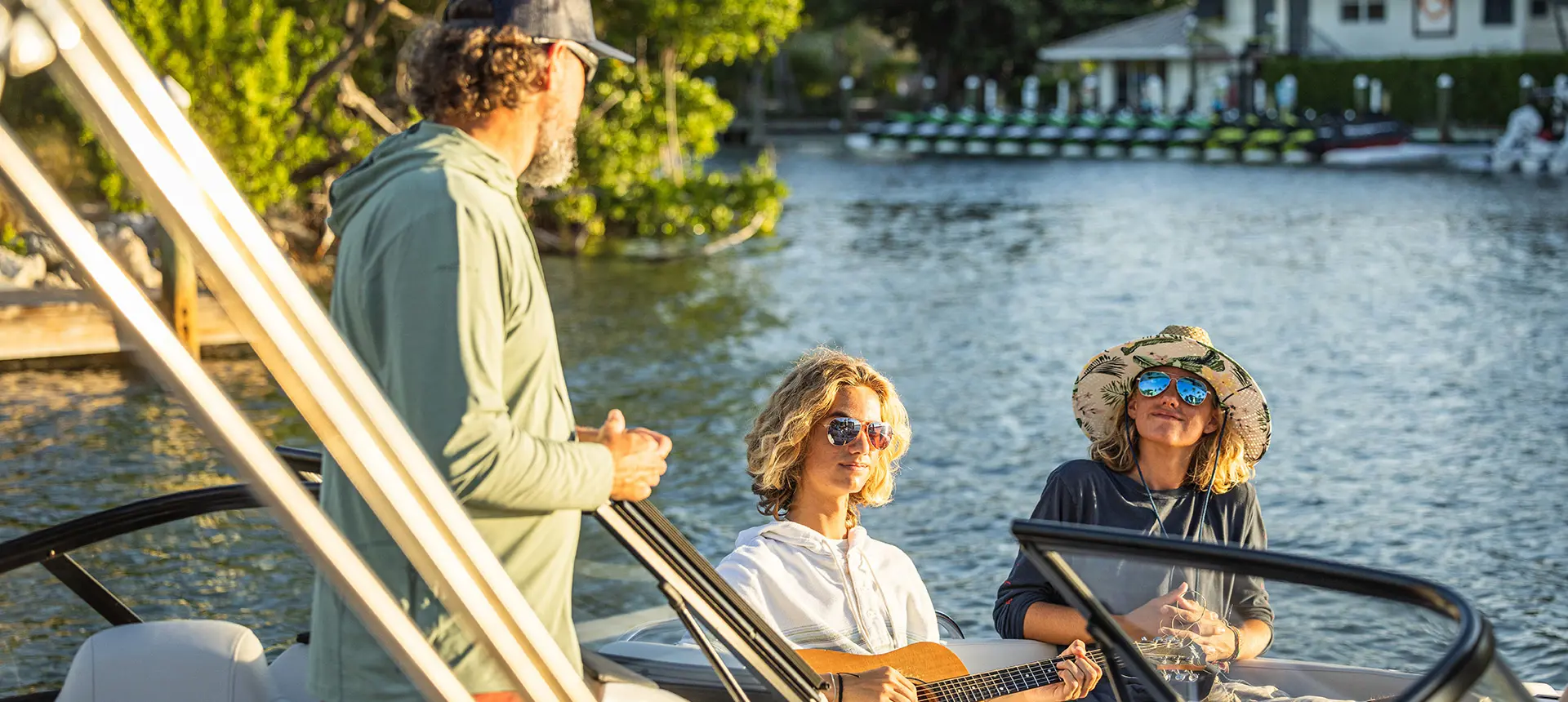 3 people enjoying the lake on a Hurricane Entertainment deck boat.