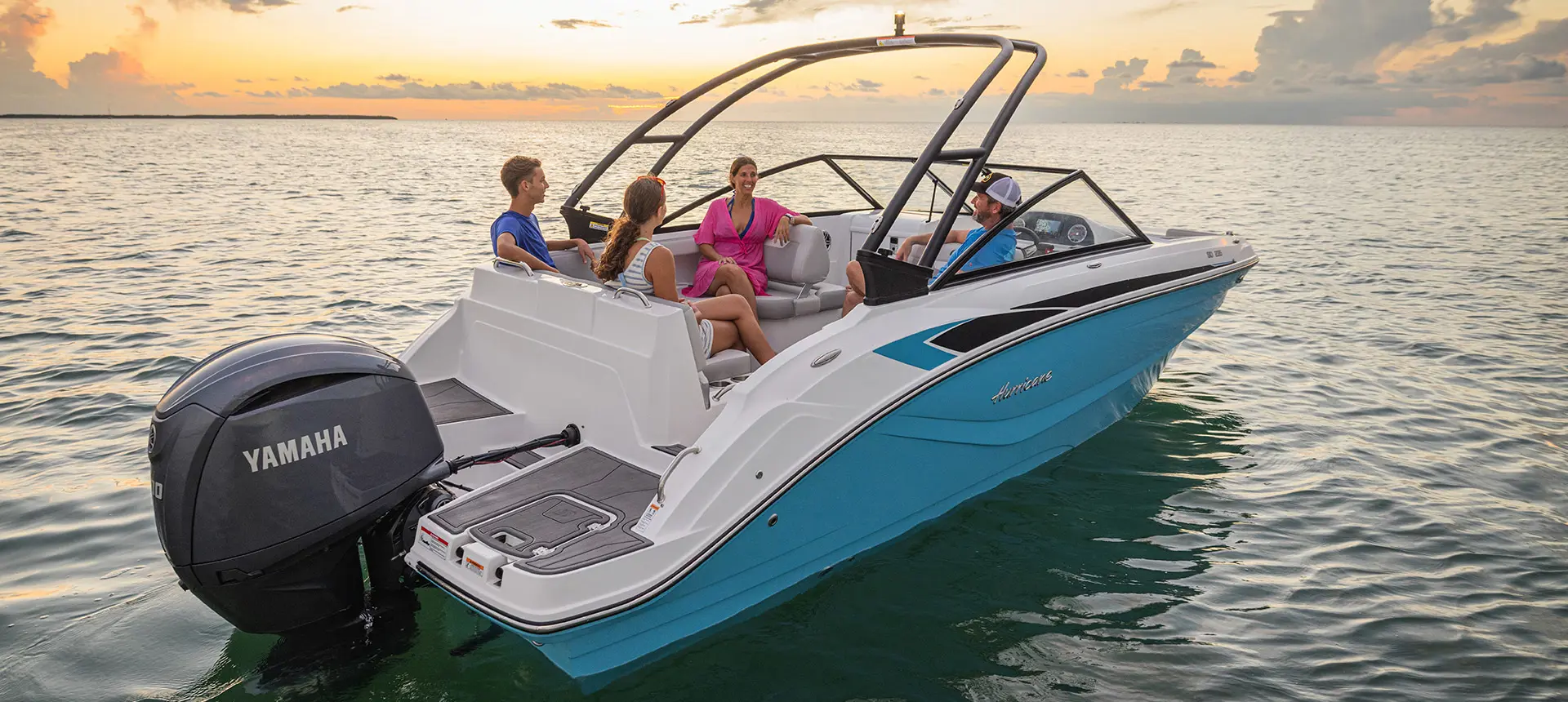 Stern focused view of 4 friends relaxing on a Hurricane Entertainment deck boat.
