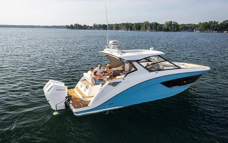 Side profile of a Hurricane SunDeck 3200 OB entertainment deck boat.