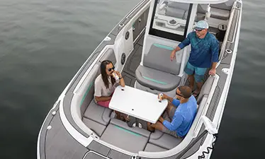 Aerial view of 3 friends at the bow table on a Hurricane Entertainment deck boat.