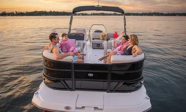 Family of 4 relaxing on the bow seating on a Hurricane Entertainment deck boat.