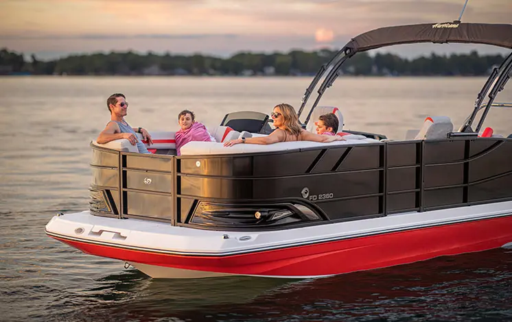 Side profile of a family relaxing on a Hurricane Entertainment deck boat.