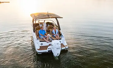 Stern focused aerial view of 2 people relaxing on a Hurricane Entertainment deck boat.