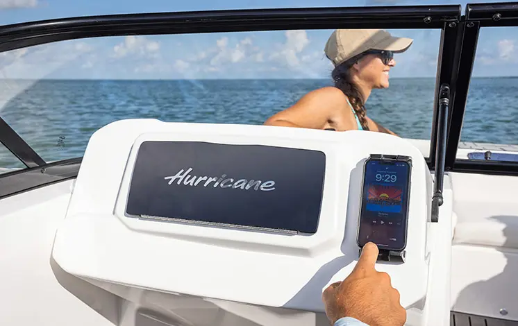 Phone holder and glovebox on a Hurricane Entertainment deck boat.
