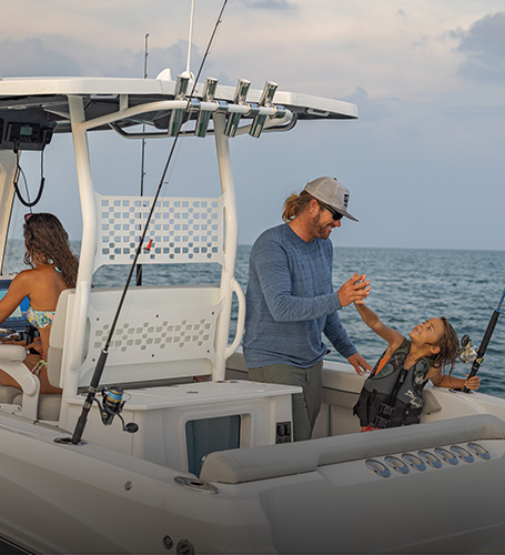 Family speeds across lake on a Hurricane Deck Boat. 