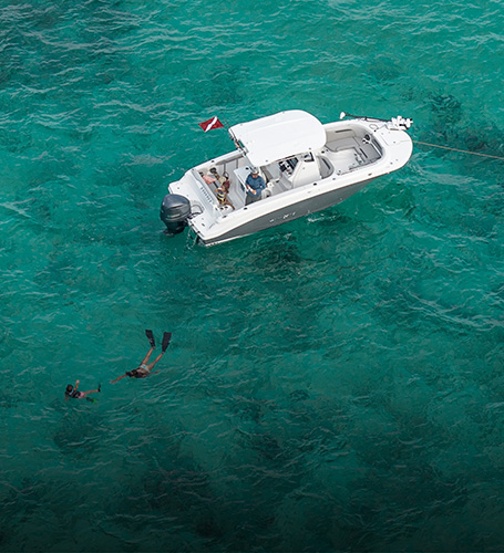Family sitting on a parked Hurricane Deck Boat. 