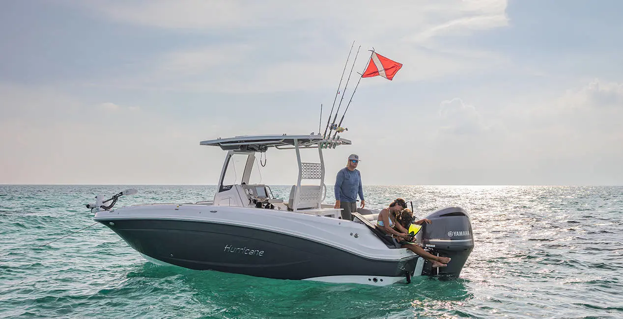 2 people preparing to snorkel off the stern of a Hurricane Center Console deck boat.