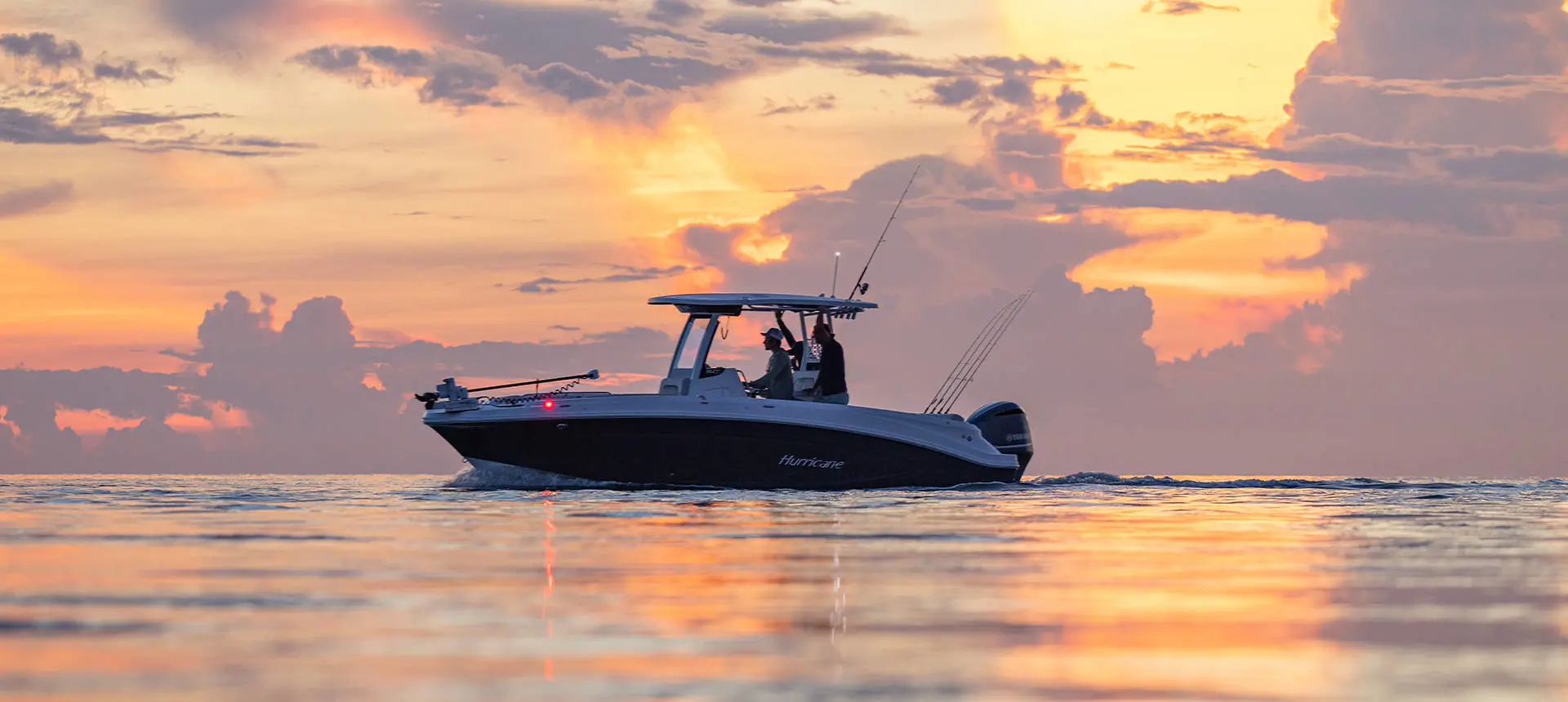 Side profile of 2 men preparing to fish on a Hurricane Center Console fishing deck boat.